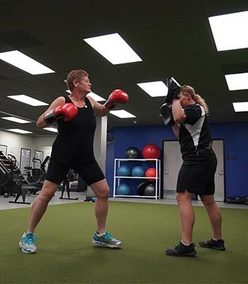 Kristi boxing with her trainer